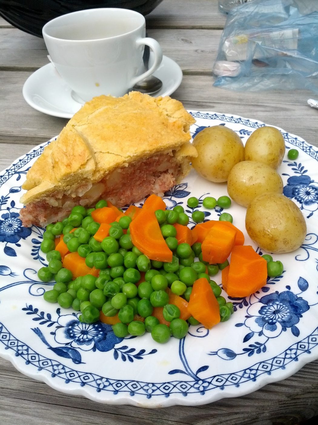 A pie with potatoes, peas and carrots